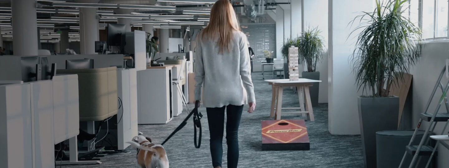 An employee and her dog, walking through the Premier Nutrition office.