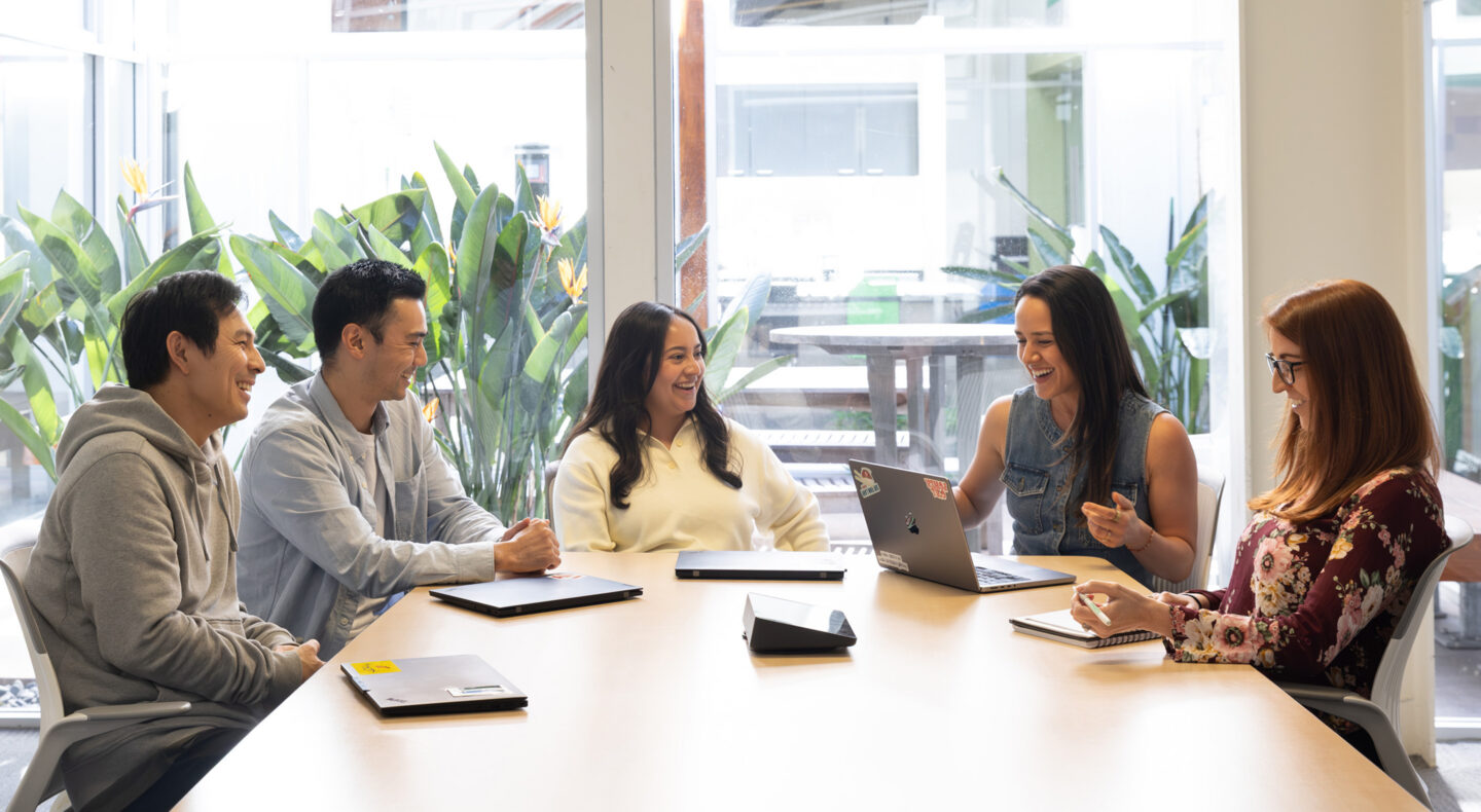Two Premier Nutrition employees at a desk in a meeting.